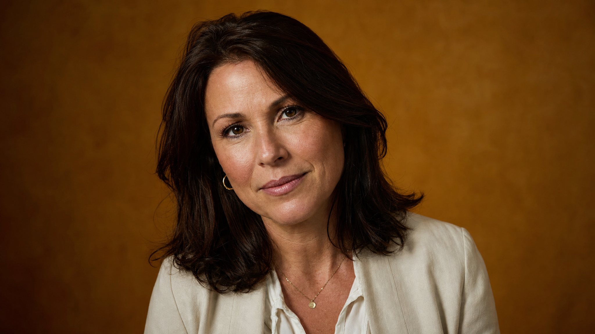 Featured author, a leadership coach, against a warm amber studio backdrop