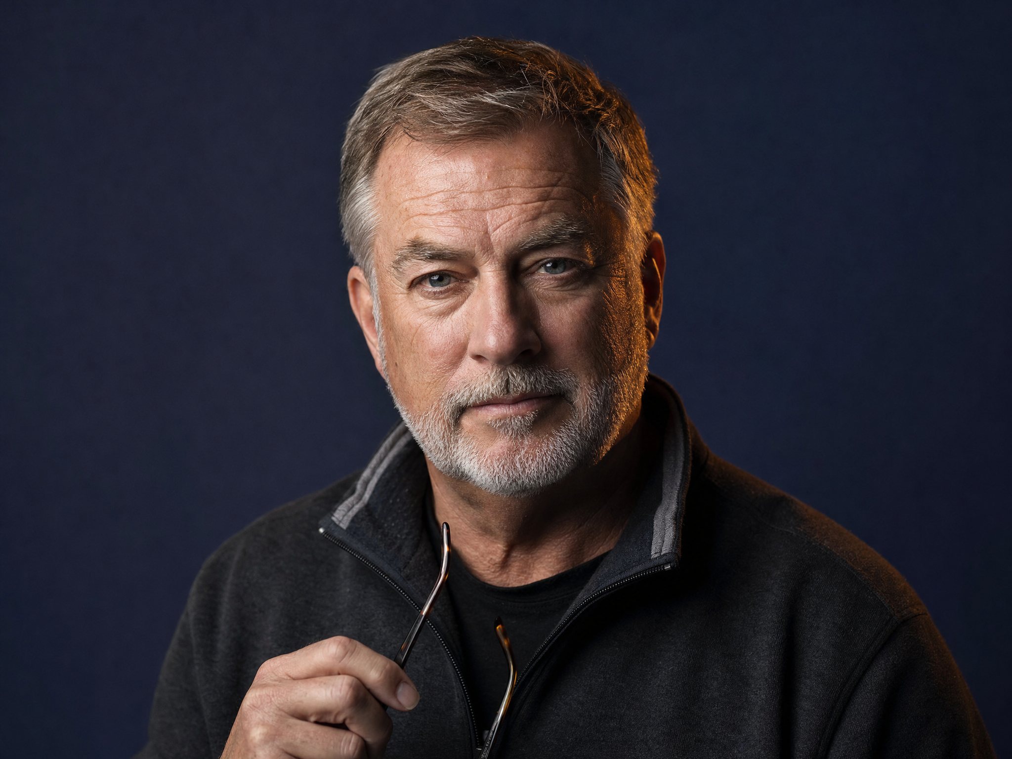 Featured author, a veteran nonprofit executive, against a deep navy studio backdrop